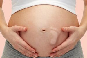 Zwangere buik met voetje